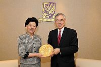 President of the All-China Women's Federation Ms. Chen Zhili (right), also vice chairperson of the Standing Committee of the National People's Congress presents a souvenir to Prof. Lawrence J. Lau (left), Vice-Chancellor of the Chinese University of Hong Kong